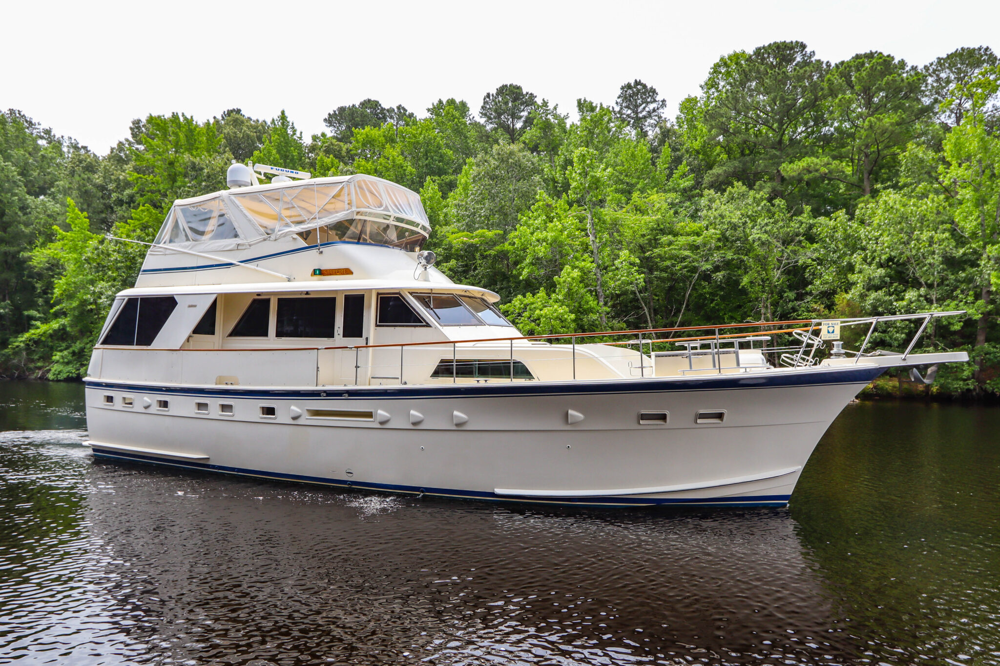 Profile of STARFIRE , a 56′ Hatteras GT yacht for sale with twin CAT engines, three staterooms and a hardtop flybridge.