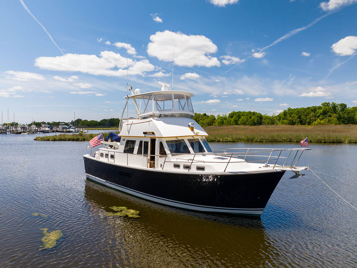 Profile of NELLIE, a 47′ Sabreline trawler yacht for sale with 2 staterooms, a U-shaped galley and a flybridge with a hardtop.