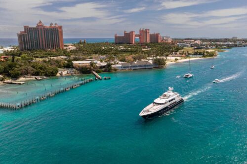 Nassau, Bahamas with Atlantis in the background and a yacht. Yacht for sale NICLE EVELYN is available on YachtR, an MLS for yachts
