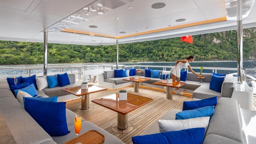 Outdoor lounge aboard TOP FIVE II, a 200-foot Royal Hakvoort yacht for charter in The Bahamas and Caribbean.