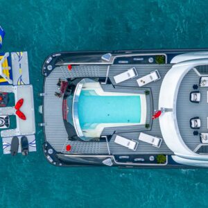 Infinity pool aerial of OKTO, a 218 foot ISA yacht for charter in the Mediterranean.
