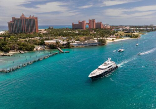 Nassau, Bahamas with Atlantis in the background and a yacht. Yacht for sale NICLE EVELYN is available on YachtR, an MLS for yachts